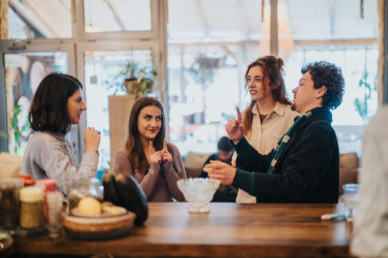Group of friends conversing and enjoying their time in a cozy cafe setting